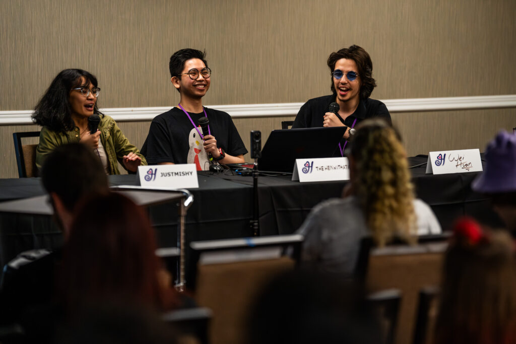 3 panelists are presenting in front of an audience